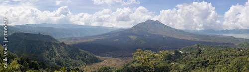 Panoramic view of the Batur volcano with frozen black lava on a clear day