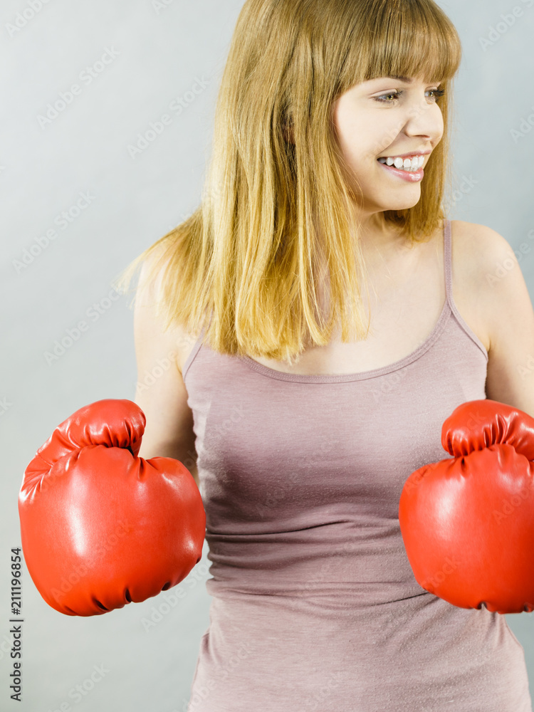 Happy smiling woman wearing boxing gloves Happy smiling woman wearing boxing gloves