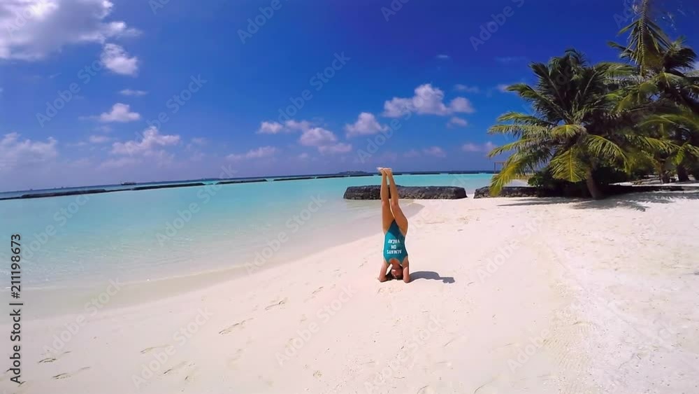 Beautiful Woman Doing Yoga on Beach, Maldives Beautiful Woman Doing Yoga on Beach, Maldives