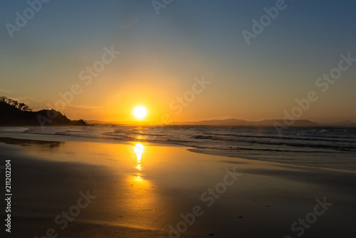 Beautiful sunset on the beach in Byron Bay, Australia. © purmakdesigns