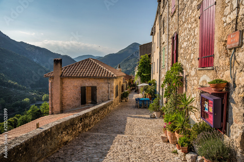 Fototapeta Naklejka Na Ścianę i Meble -  Cafe and laneway in the mountain village of Saint Agnes in the Alps Maritime near Menton, South of France