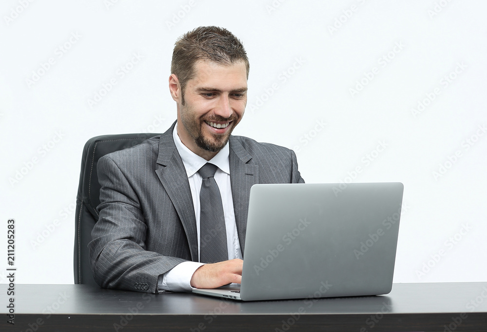 closeup.happy businessman working on laptop, sitting at desk closeup.happy businessman working on laptop, sitting at desk