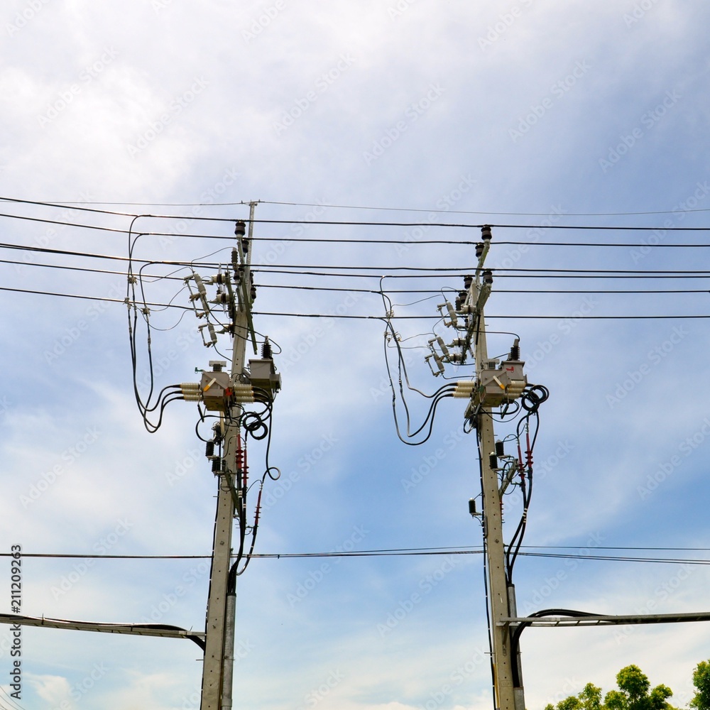 Parallel lines of telephone cables supported by concrete pylons, isolated against a blue sky Parallel lines of telephone cables supported by concrete pylons, isolated against a blue sky