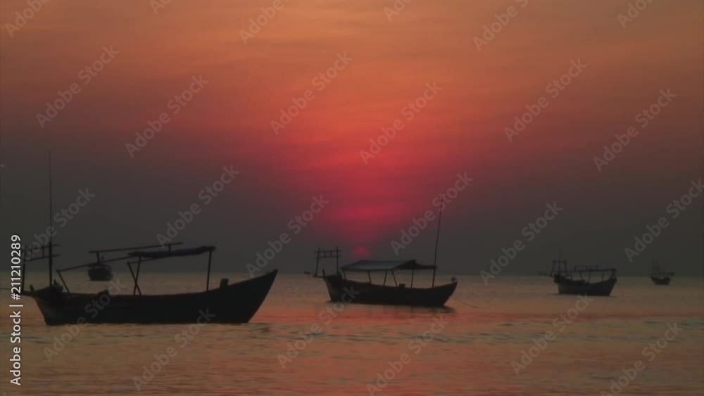 Row of Boats Under Barely Visible Red Sun Row of Boats Under Barely Visible Red Sun