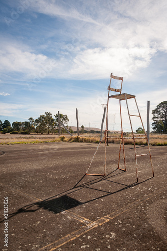 Umpires chair on abandoned tennis court