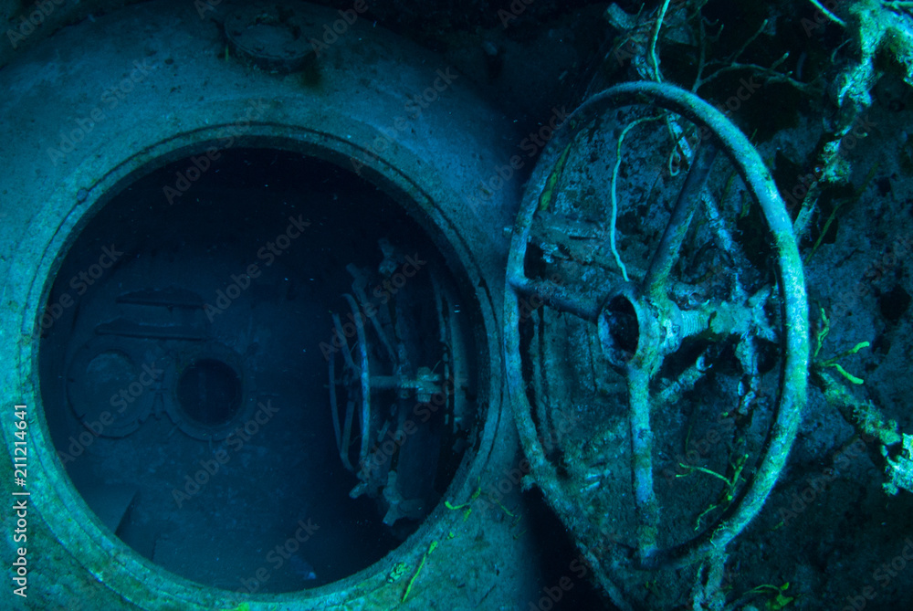 An underwater shot inside a room in the shipwreck of the Kittiwake that uses natural light as opposed to a strobe. The wreck has been sunk deliberately and is shallow enough to allow light penetration