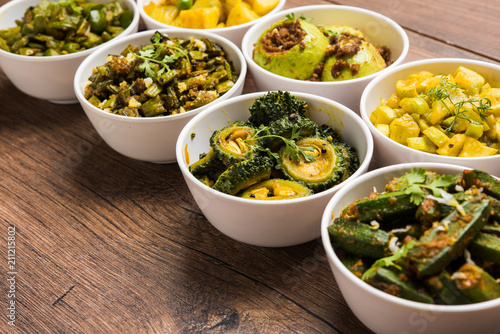 Indian sabzi / vegetable fried recipes served in white bowl over moody or colourful background. selective focus