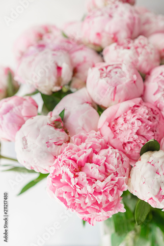 Beautiful bouquet of pink peonies . Floral composition, daylight. Wallpaper. Lovely flowers in glass vase.