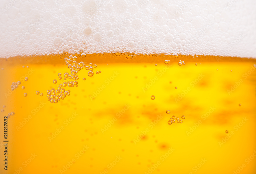 Pouring beer with bubble froth in glass for background. Summer drink texture Pouring beer with bubble froth in glass for background. Summer drink texture