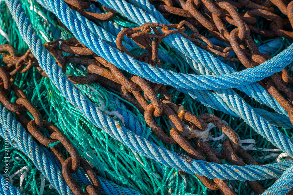 Abstract of various blue, green ropes and rusty chains