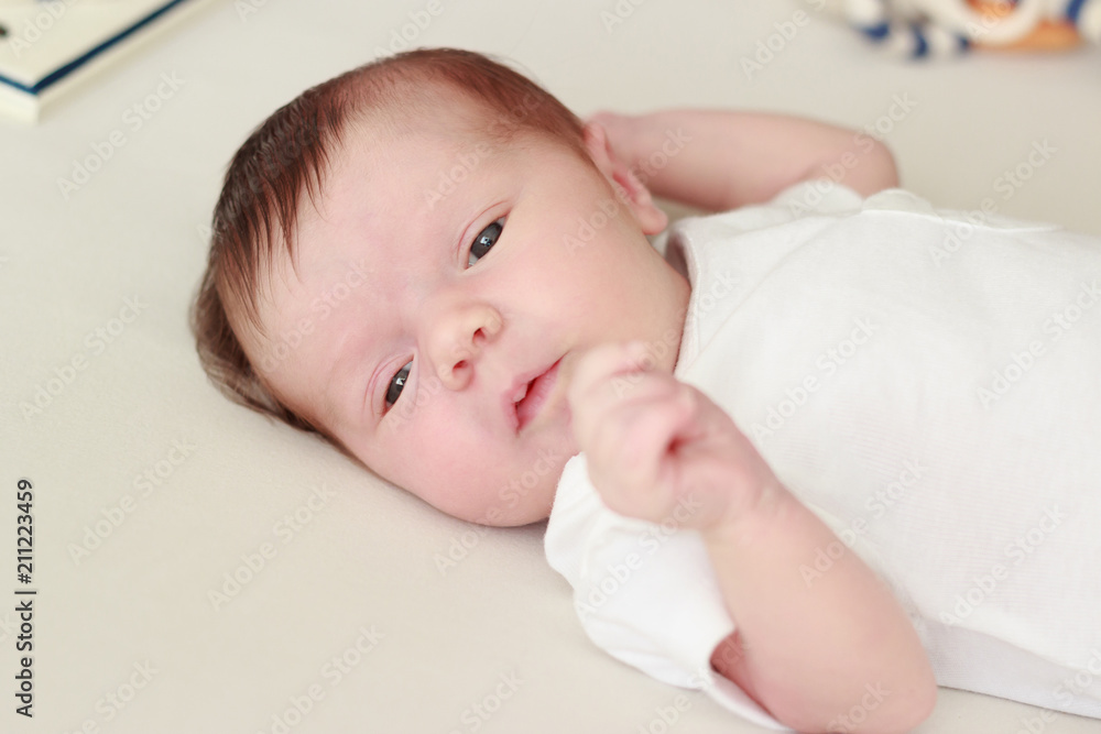 Portrait of a newborn baby laying on a blanket Portrait of a newborn baby laying on a blanket