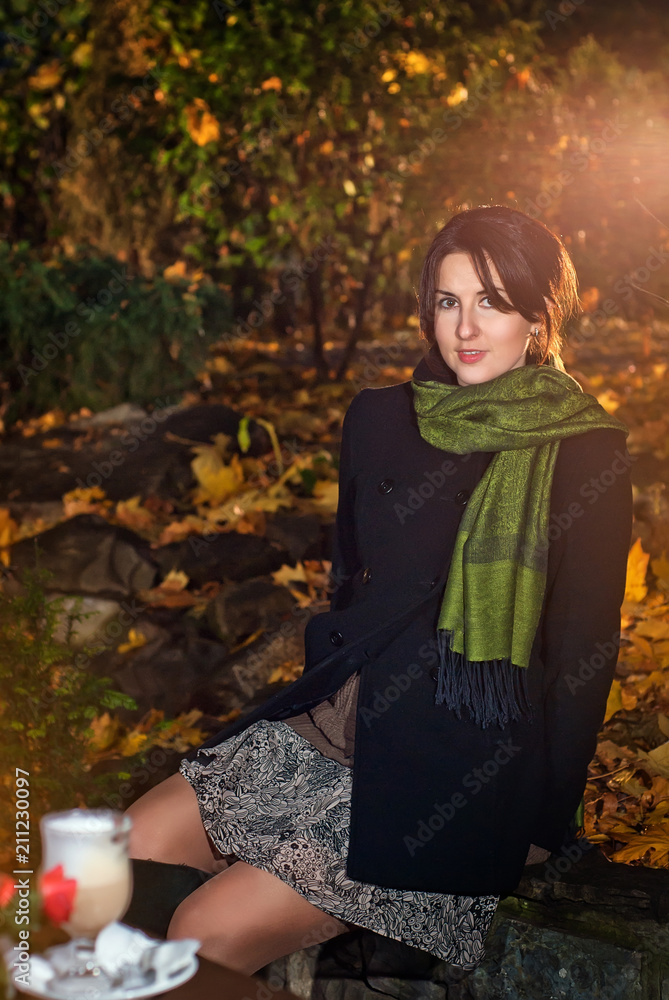 girl in the autumn evening with a scarf