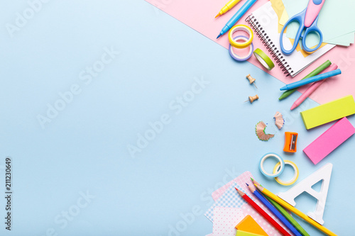 Colorful stationary school supplies on blue trending background, space or text flat lay photo