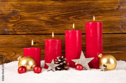 red advent candles with balls and stars