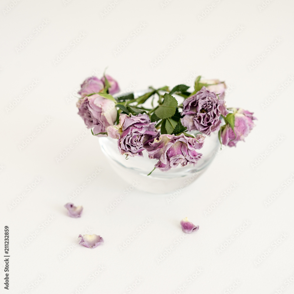 Flowers pink dry roses in a round transparent vase Flowers pink dry roses in a round transparent vase