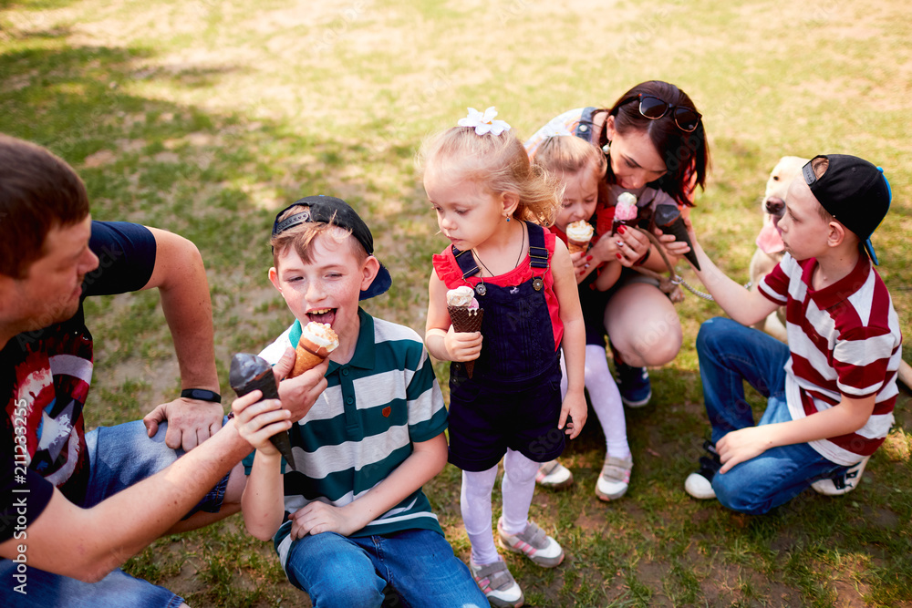 The mother,father and children eatting ice creams in the park The mother,father and children eatting ice creams in the park