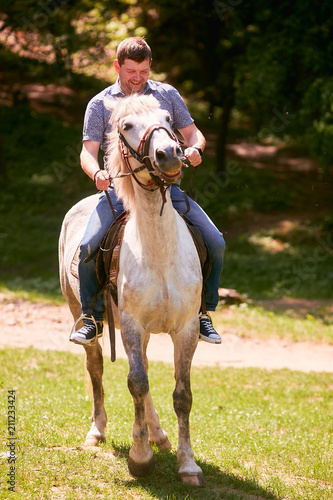 The handsome man riding on horse