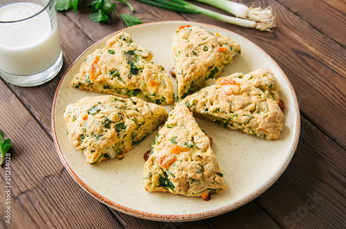 Savory scones with feta mozzarella and green herbs on a plate.