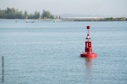 Navigation mark buoy red, floating in the morning sea