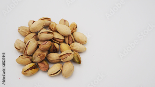 Pistachios on white background.It's roasted dried green nut or shell  close up  top view healthy snack  .
