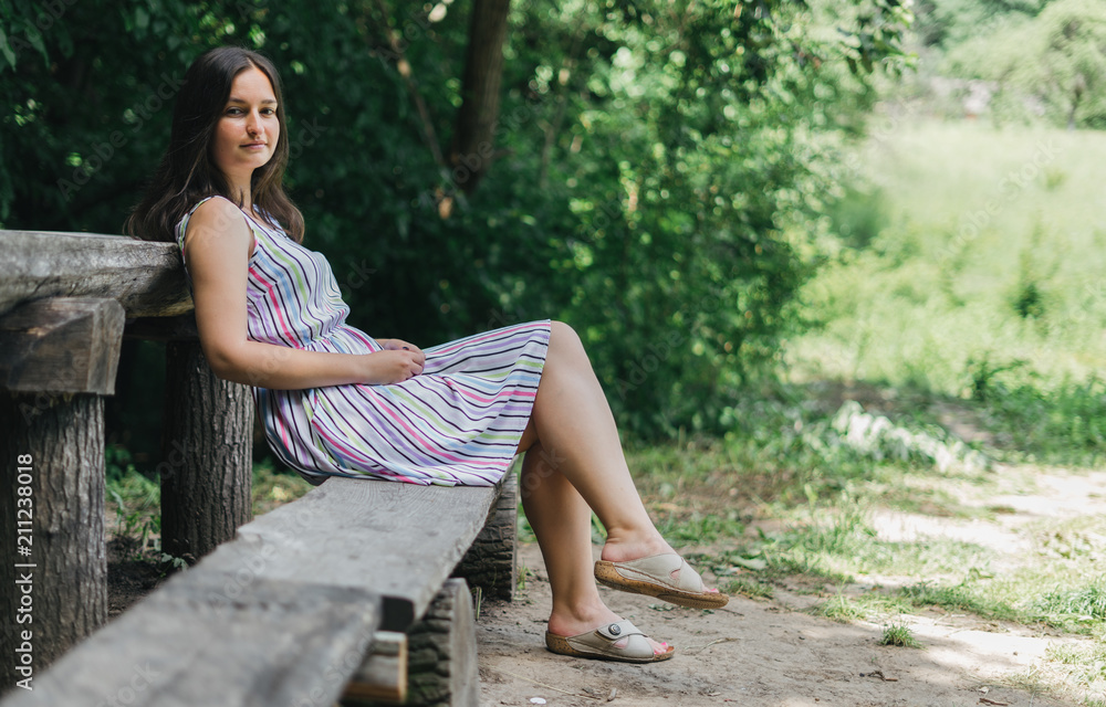 Young girl sitting in bench on summer sunny day. Young girl sitting in bench on summer sunny day.