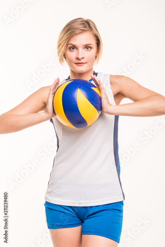  Girl playing volleyball on a light background