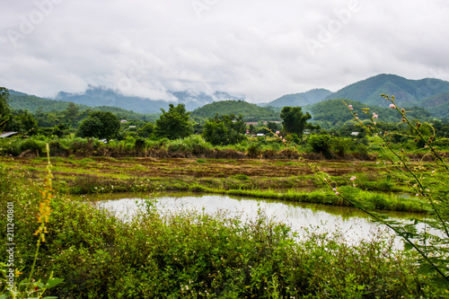 Farm and scenic view of mountains and sky in northern Thailand.