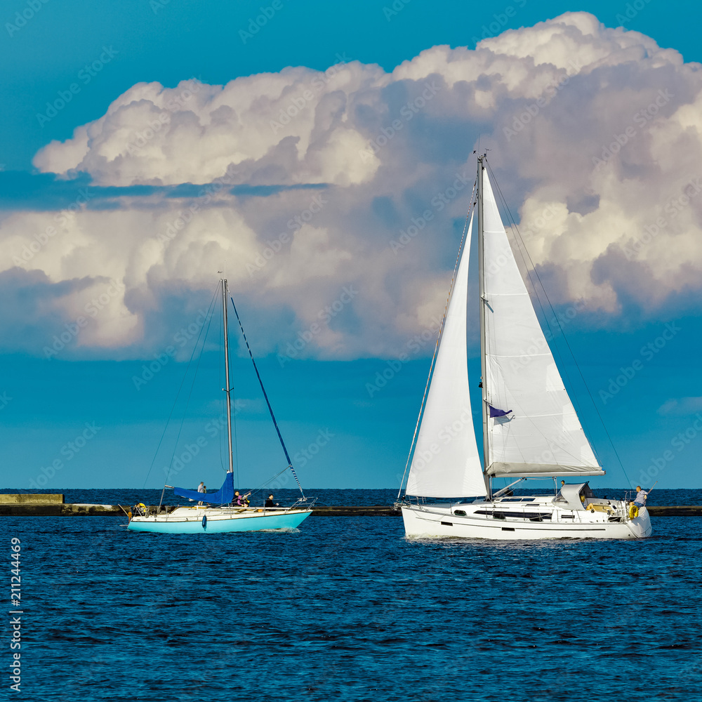 Sailboats traveling by Baltic sea