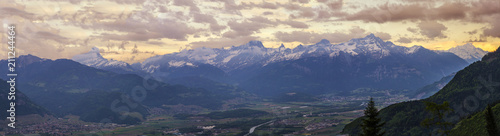 This fantastic panoramic image shows the Franco Swiss Alps in all the splendour. The beautiful Swiss Valais Valley  basks in the lustre of twilights glow. The Greffaz river meanders through the valley