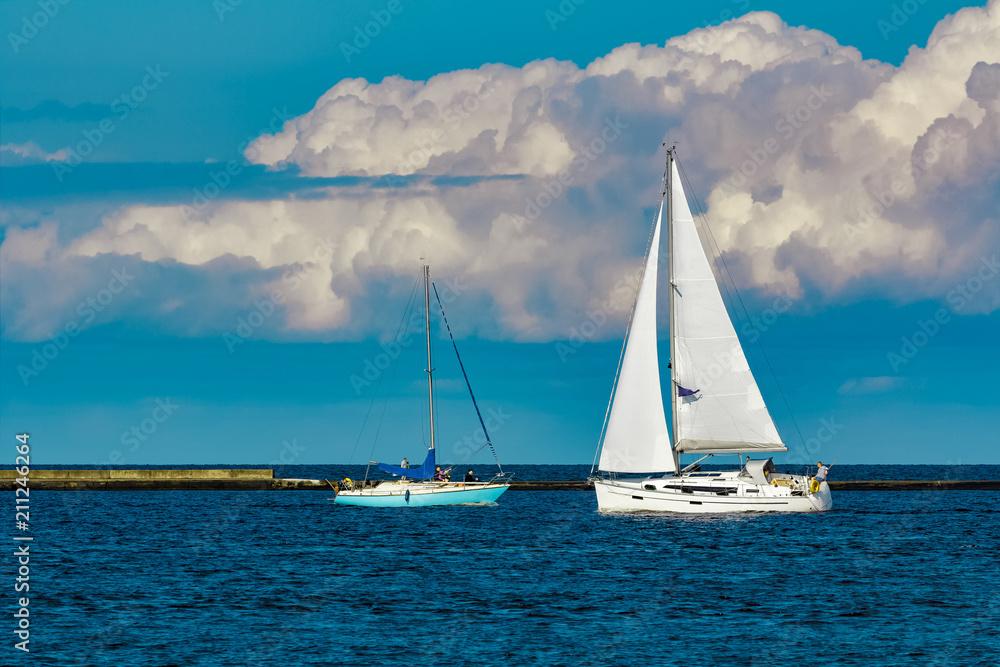 Sailboats traveling by Baltic sea