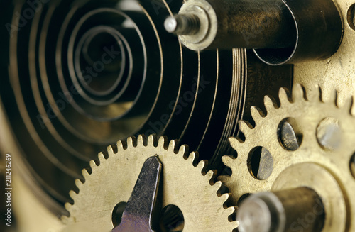 Closeup of gears and cogs clockwork and clock springs. Inside mechanism, clockwork with working gears.