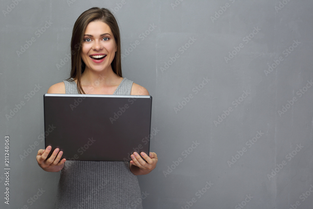 Young woman holding open laptop. Young woman holding open laptop.