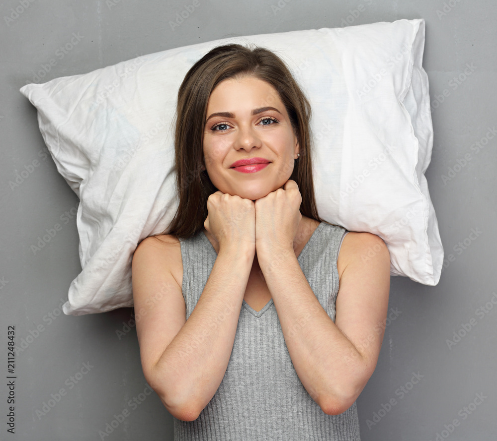Smiling woman lying on white pillow. Smiling woman lying on white pillow.