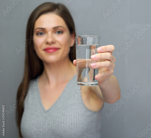 Lifestyle portrait with woman holding water glass.