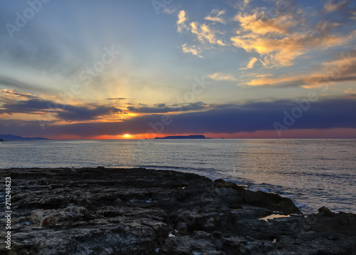 Sunset with golden light beautiful cloud at black sand beach in southeast Iceland Crete.