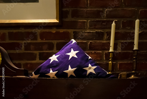 Folded flag sitting on the mantel after the military honors funeral.