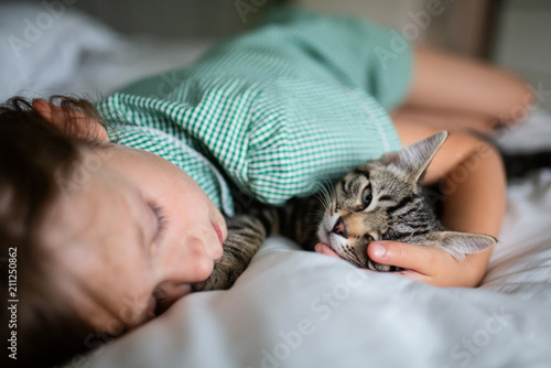 Female child sleeping with her cat