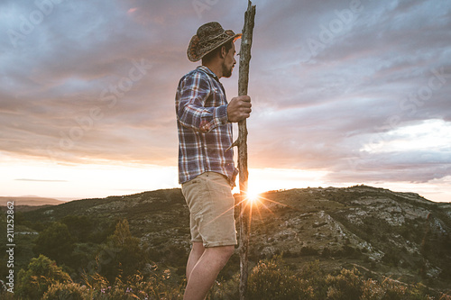 Cowboy in the mountains and a sunset