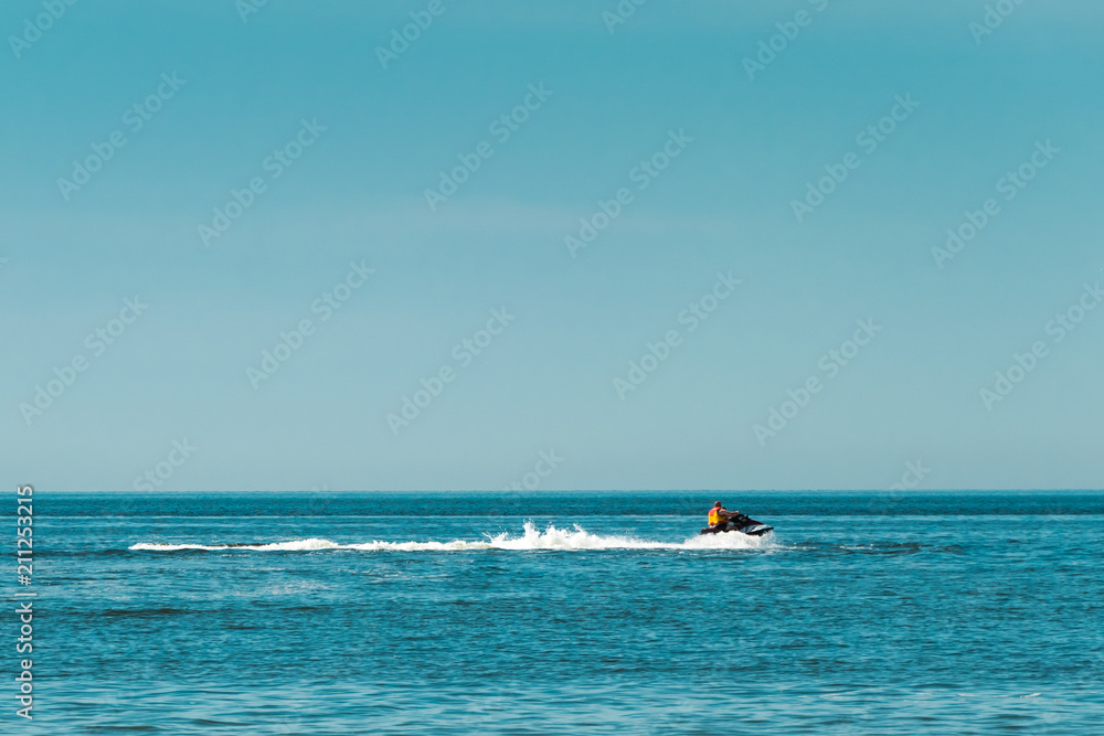 two people on a jet ski floating on the sea