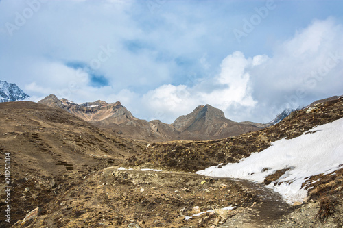 Mountain landscape with snow on the trail and white clouds, Nepal. © Valery Smirnov