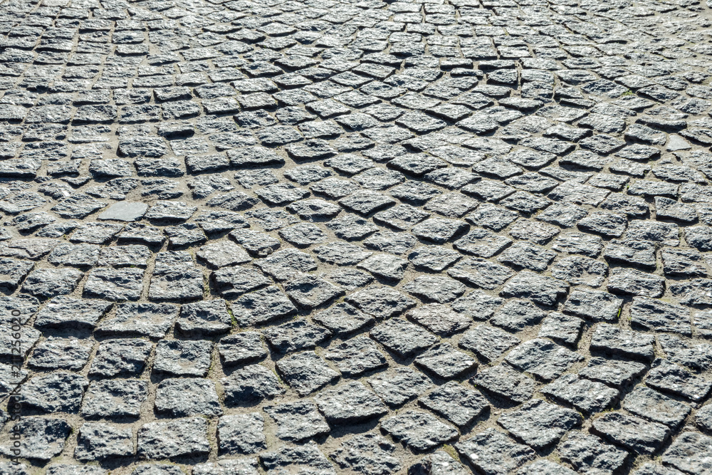 Cobblestone pavement. Texture stone pavement. Cobbles texture - hard pavement, a kind of pavement.