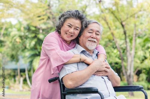Happy elderly couple with lifestyle after retiree concept. Lovely asian seniors couple embracing together in the park in the morning.