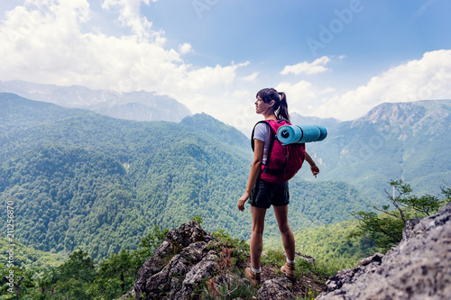 Female hiker enjoying beautiful mountain view photo