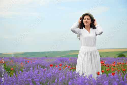 young girl is in the lavender field, beautiful summer landscape with flowers