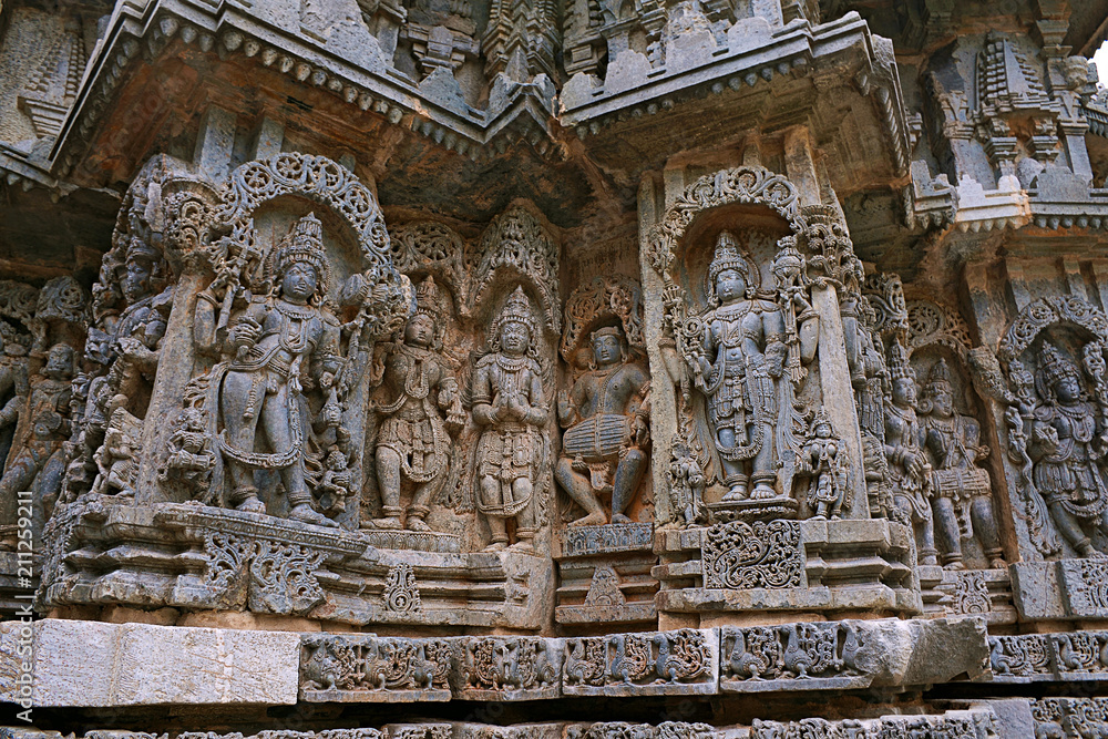 Ornate wall panel reliefs depicting from left Bhairava, Other deities, a drumer and Lord Vishnu, Kedareshwara temple, Halebidu, Karnataka