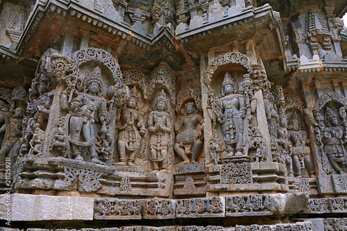 Ornate wall panel reliefs depicting from left Bhairava, Other deities, a drumer and Lord Vishnu, Kedareshwara temple, Halebidu, Karnataka photo
