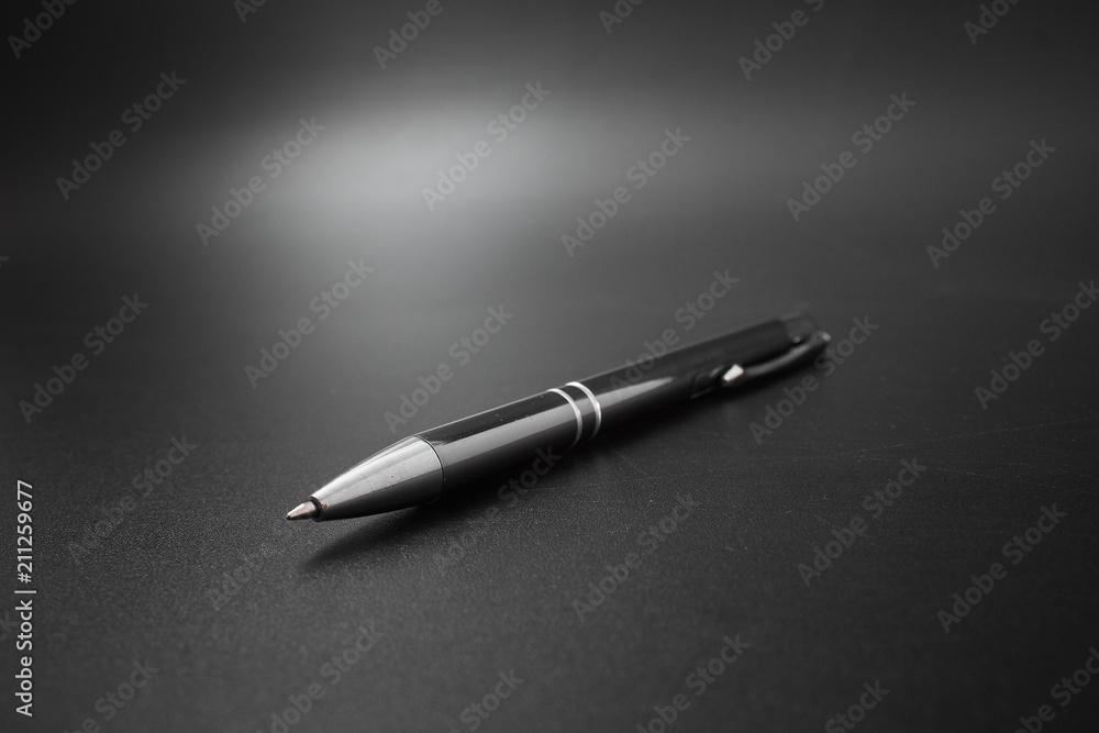 metal ballpoint pen on a black background. metal ballpoint pen on a black background.