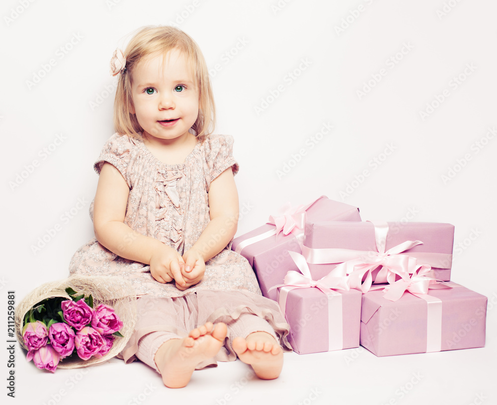 Beautiful child girl with flowers and pink gift box, birthday background Beautiful child girl with flowers and pink gift box, birthday background