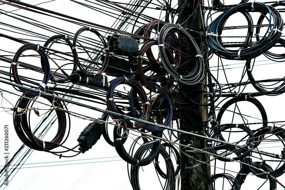 Tangled electrical wires on urban electric pole. Disorganized and messy to organization management concept