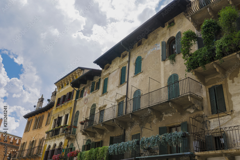 Verona, Italy Piazza delle Erbe buildings. Day view of traditional houses with balconies at Market square.
